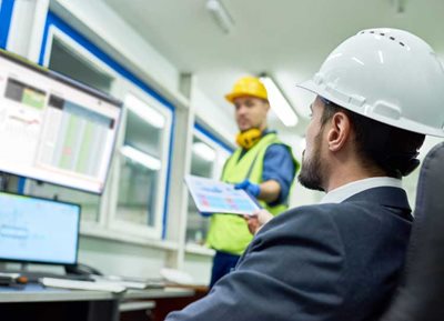 construction worker handing reports to his coworker